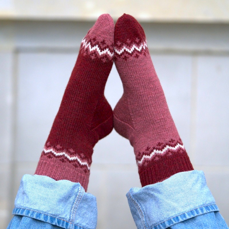 Fun contrasting sock with a beautiful colorwork detail suited for beginner knitters.