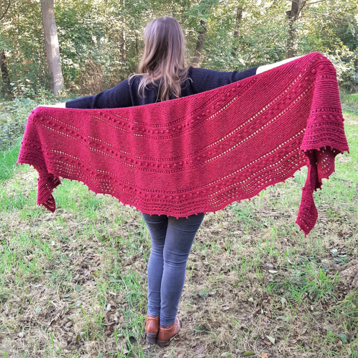  A crescent shapes shawl that comes in two sizes featuring a beautiful eyelet and bobble pattern and a ripple edge.